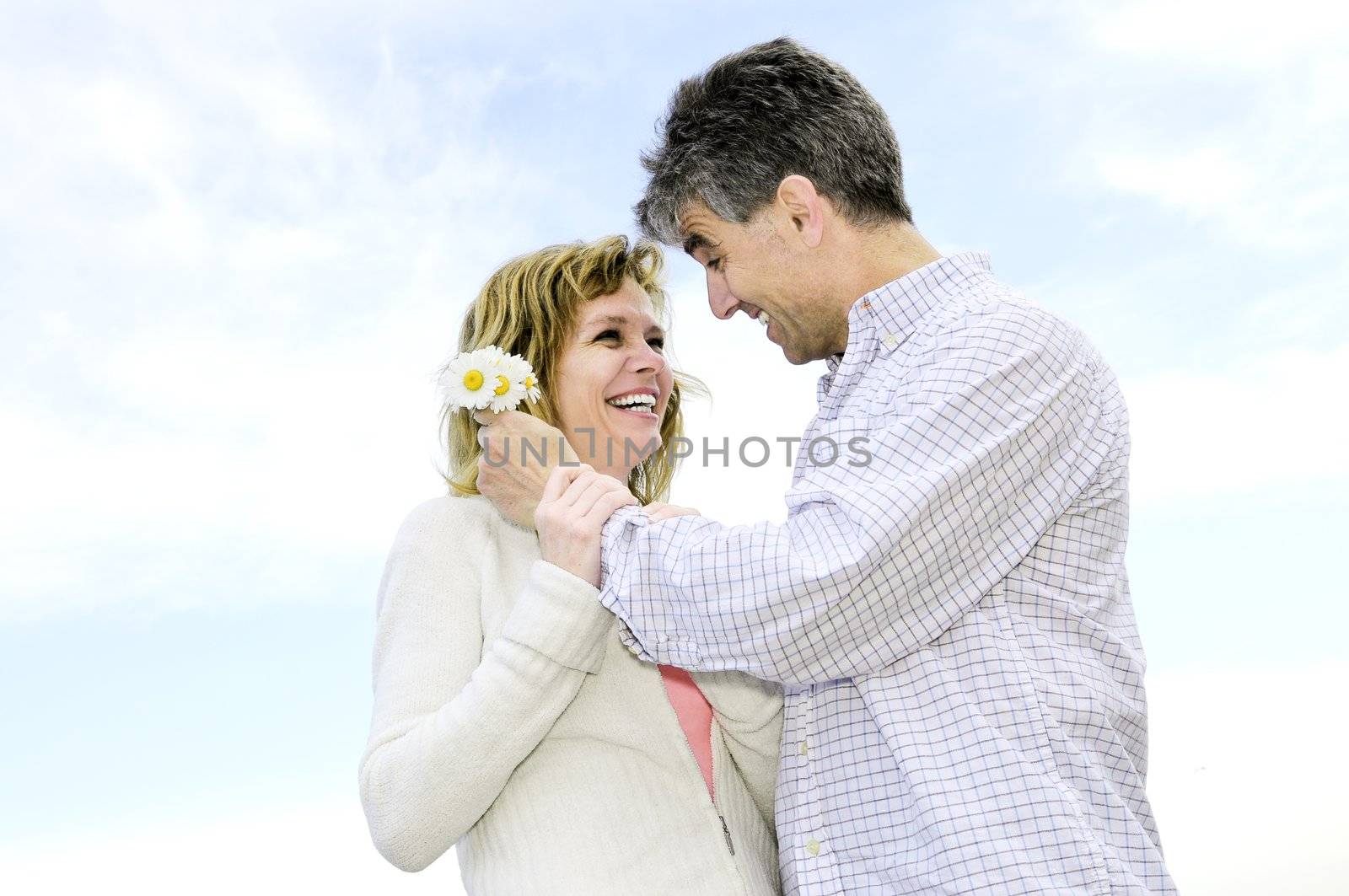 Mature couple enjoying a romantic moment with flowers