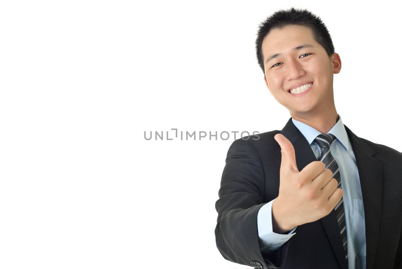 Smiling young businessman give you a excellent sin with copyspace on white.