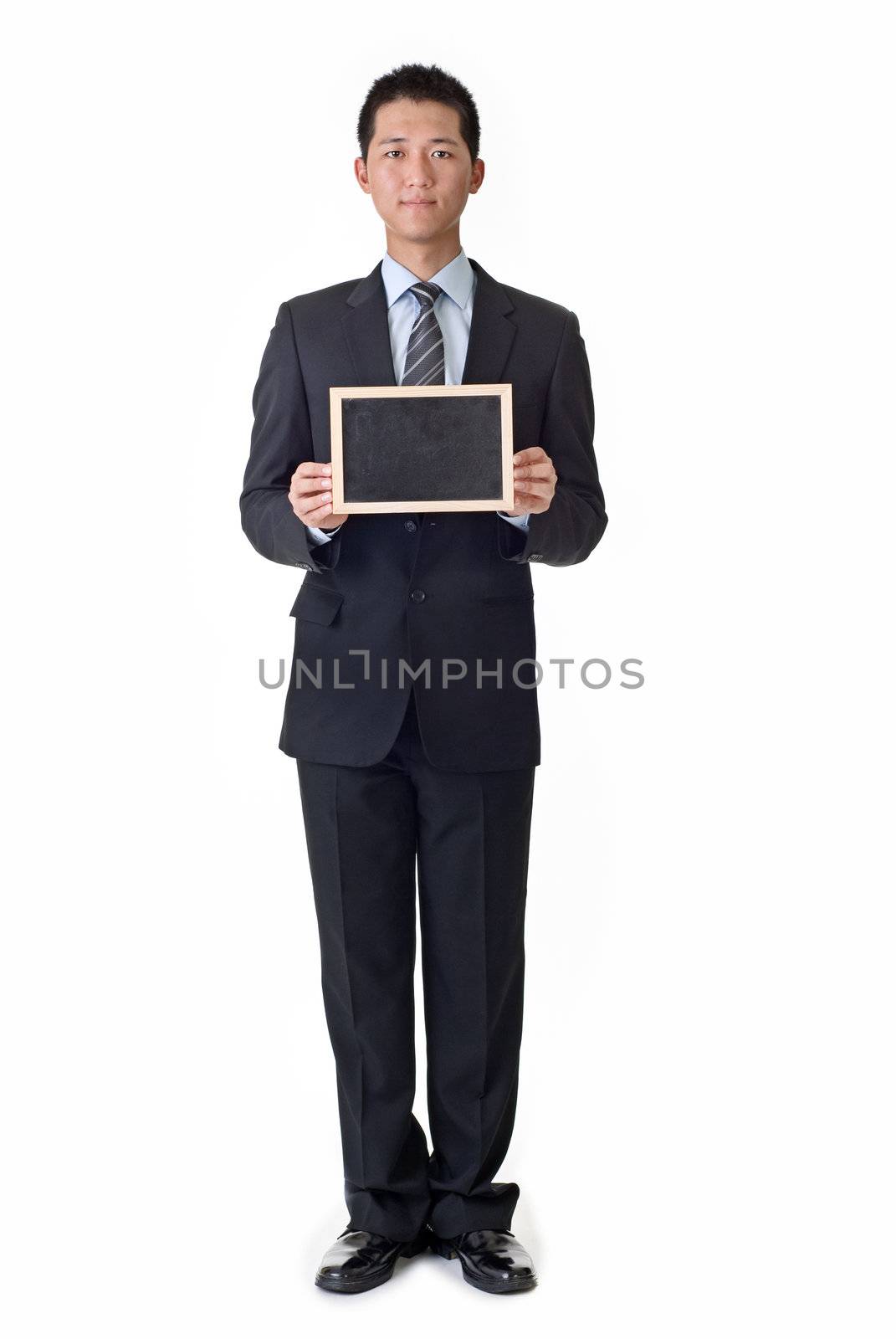 Businessman holding blank blackboard, isolated on white background.