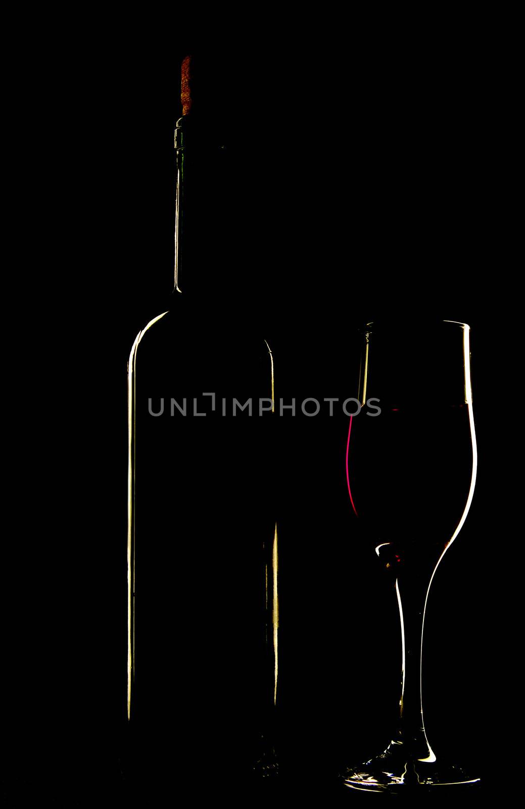light silhouette of bottle and wineglass by palomnik