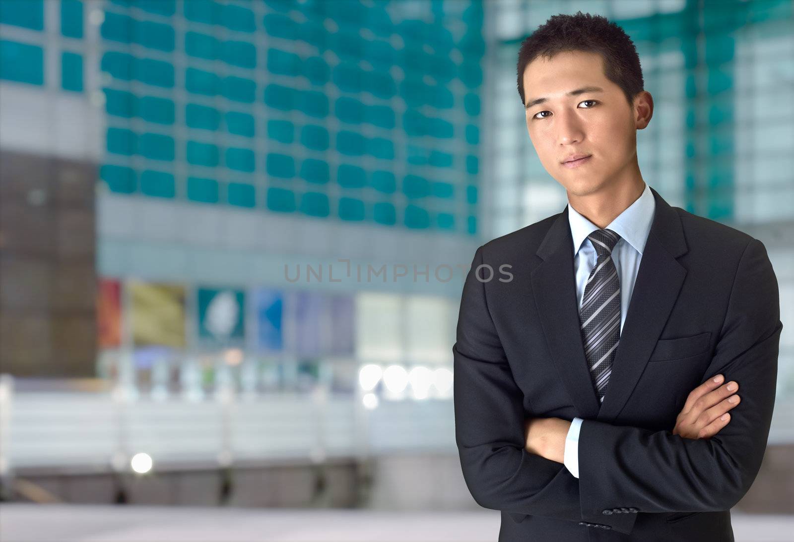 Confident young business man outside of office, closeup portrait of Asian.