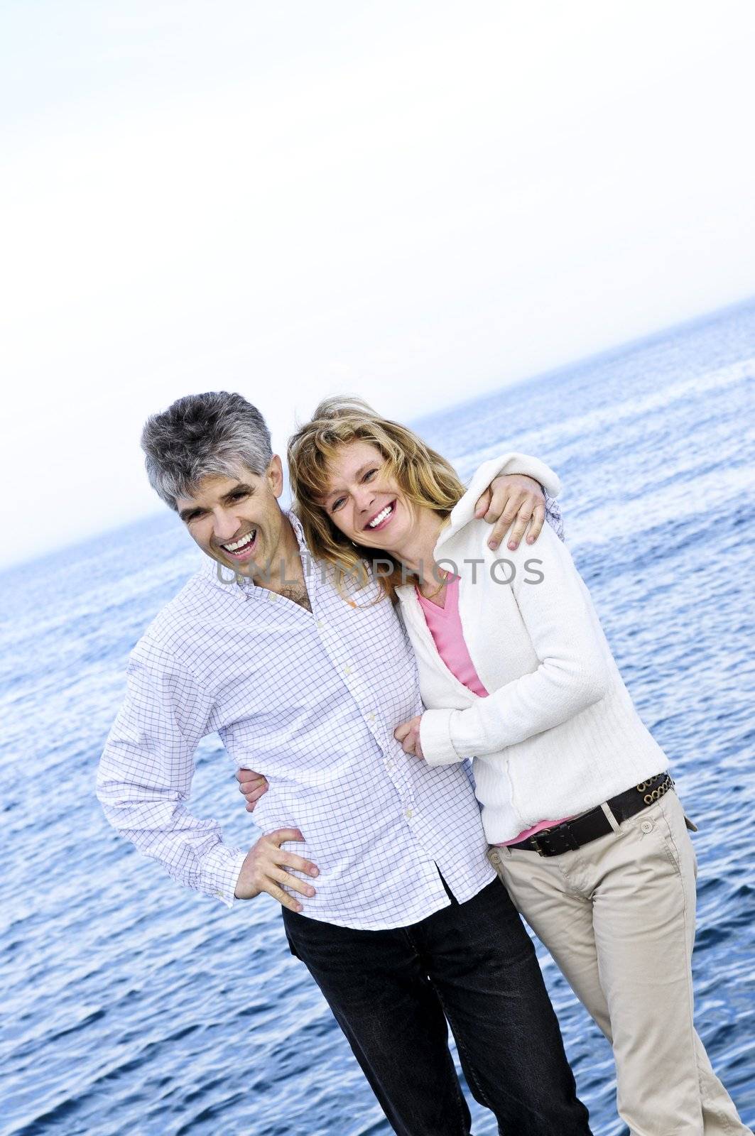 Mature romantic couple at seashore by elenathewise