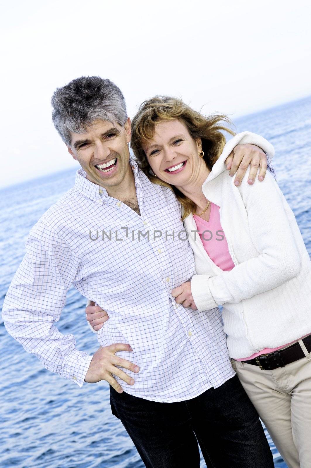 Mature romantic couple at seashore by elenathewise