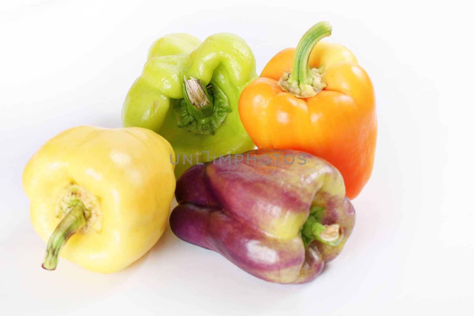 shot of assorted colorful peppers on white by creativestock