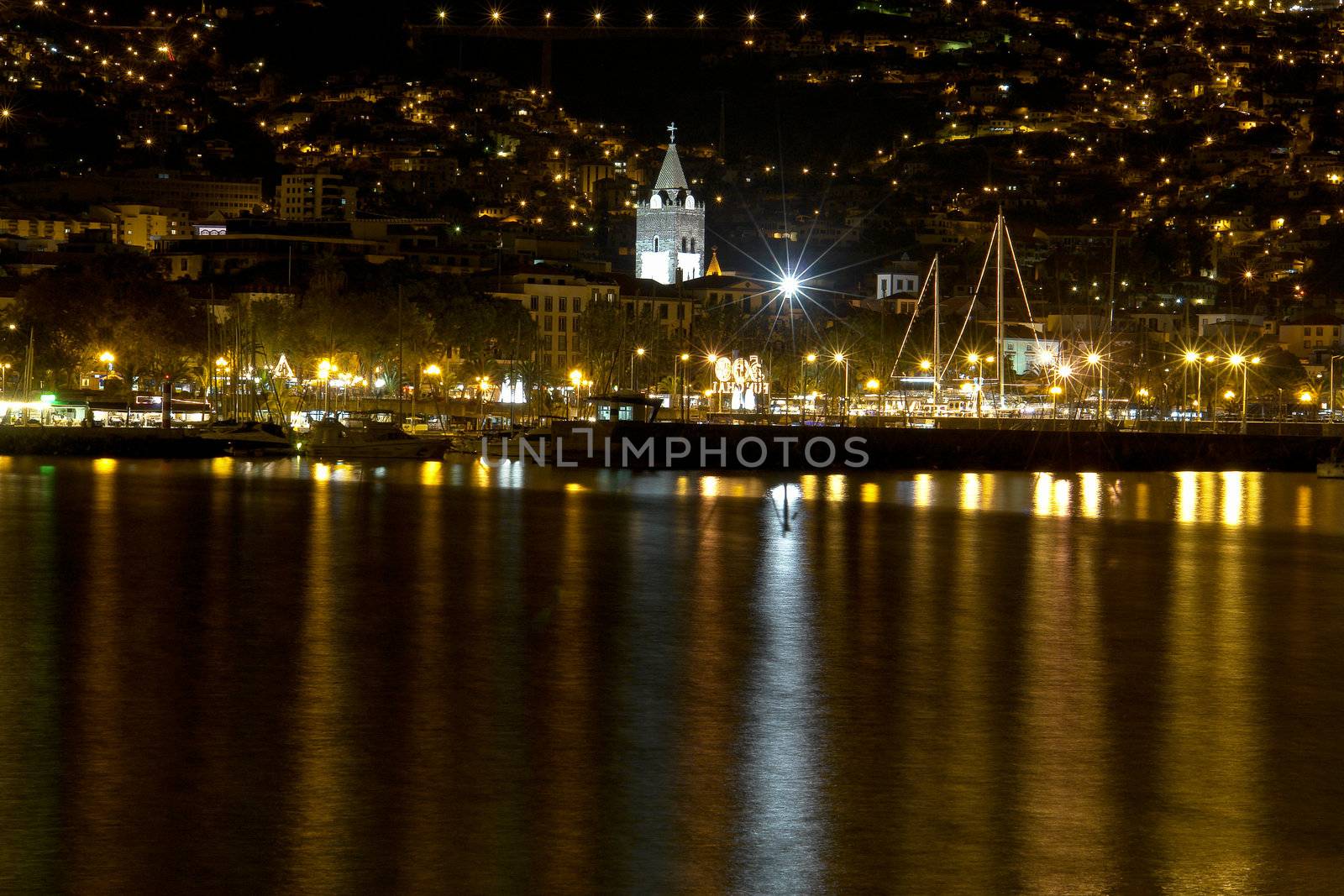 Night photo of a city by the sea in Funchal, Madeira.