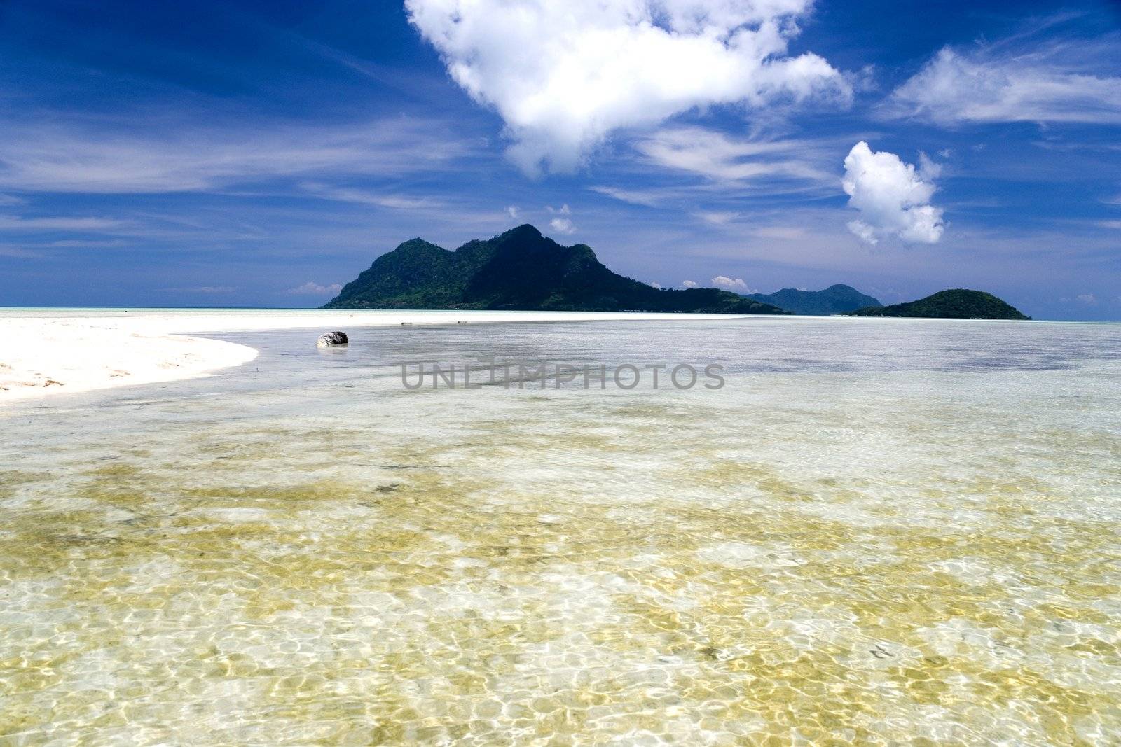 Image of remote Malaysian tropical islands with deep blue skies and crystal clear waters.
