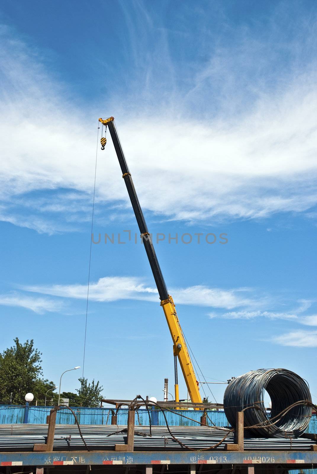 solated yellow  mobile crane with boom up