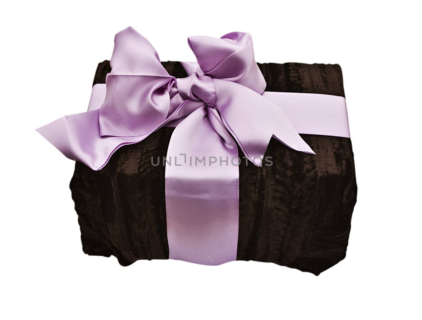 A present wrapped with soft brown material and a satin bow
