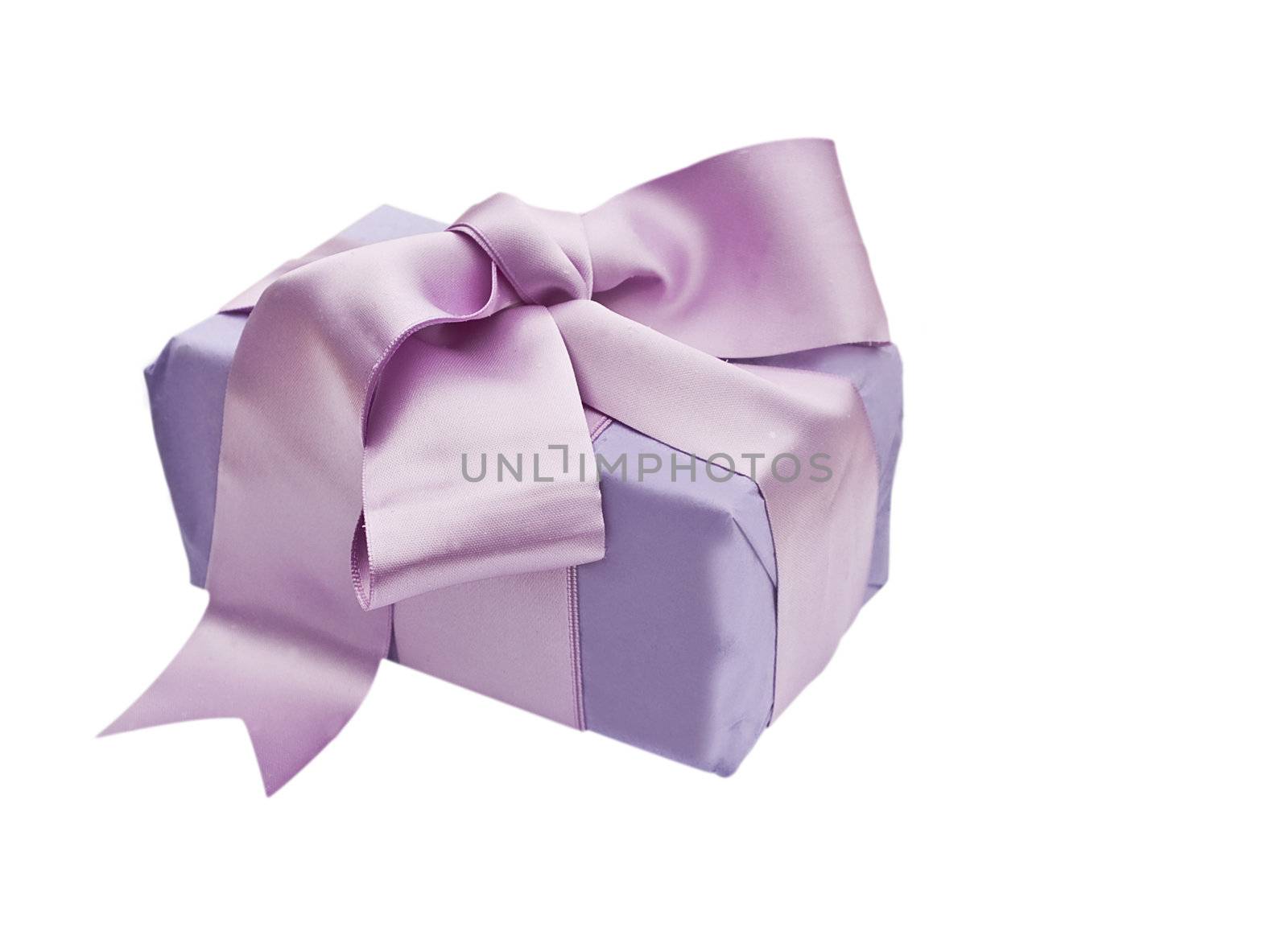 Gift box wrapped with wrapping tissue and a satin bow isolated on a white background

