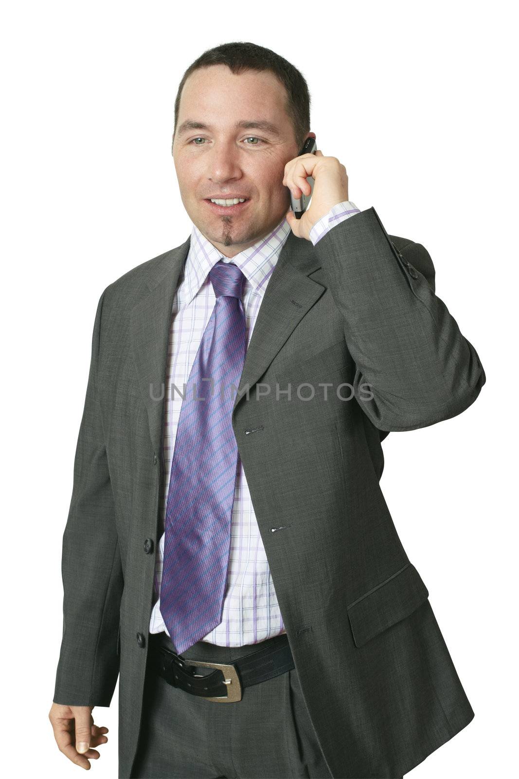 A handsome businessman receiving good news on his cellphone.