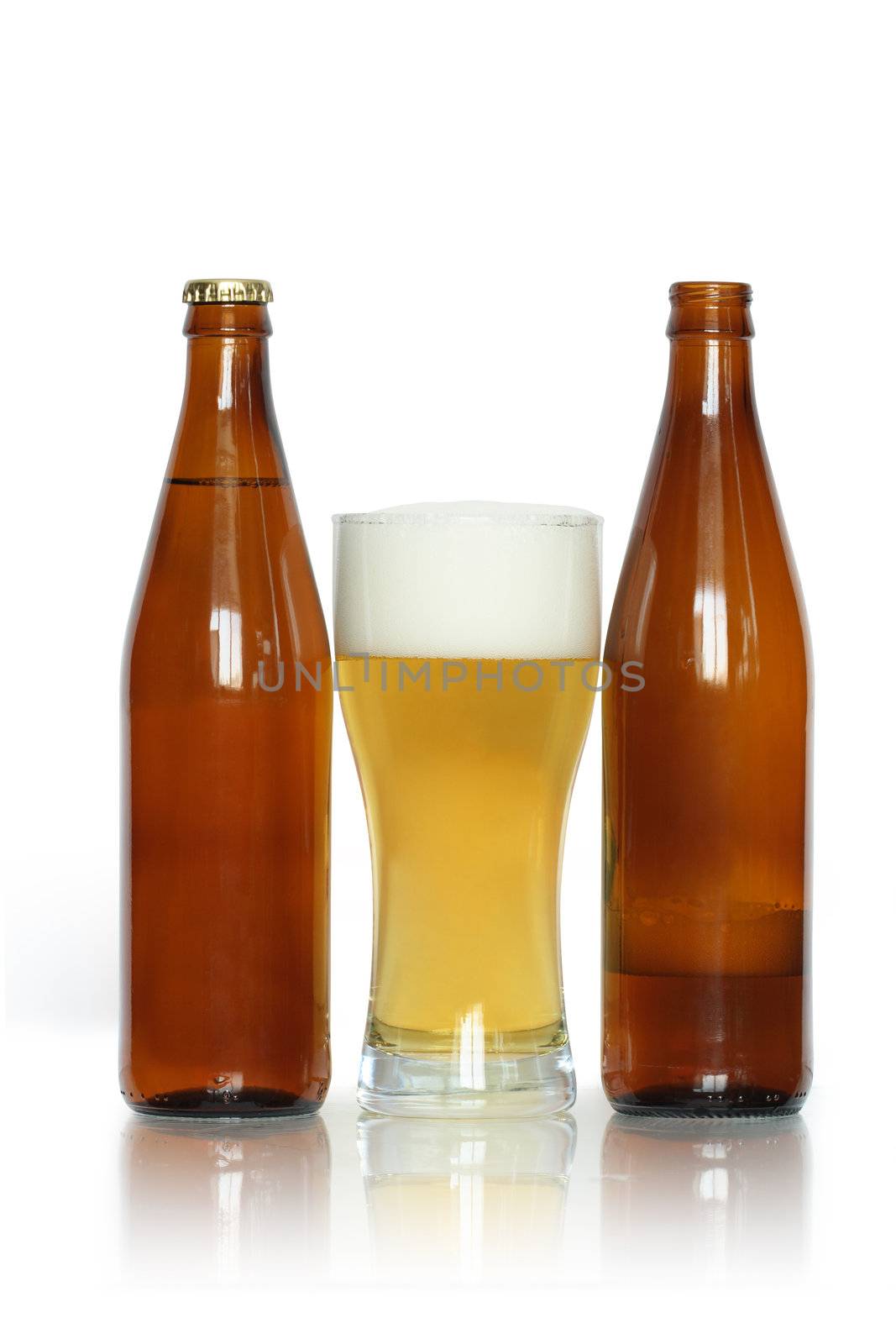 Glass of lager beer near two bottles isolated on white background with clipping path