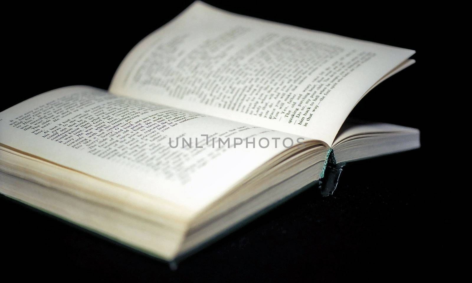 Pages of open book on black background