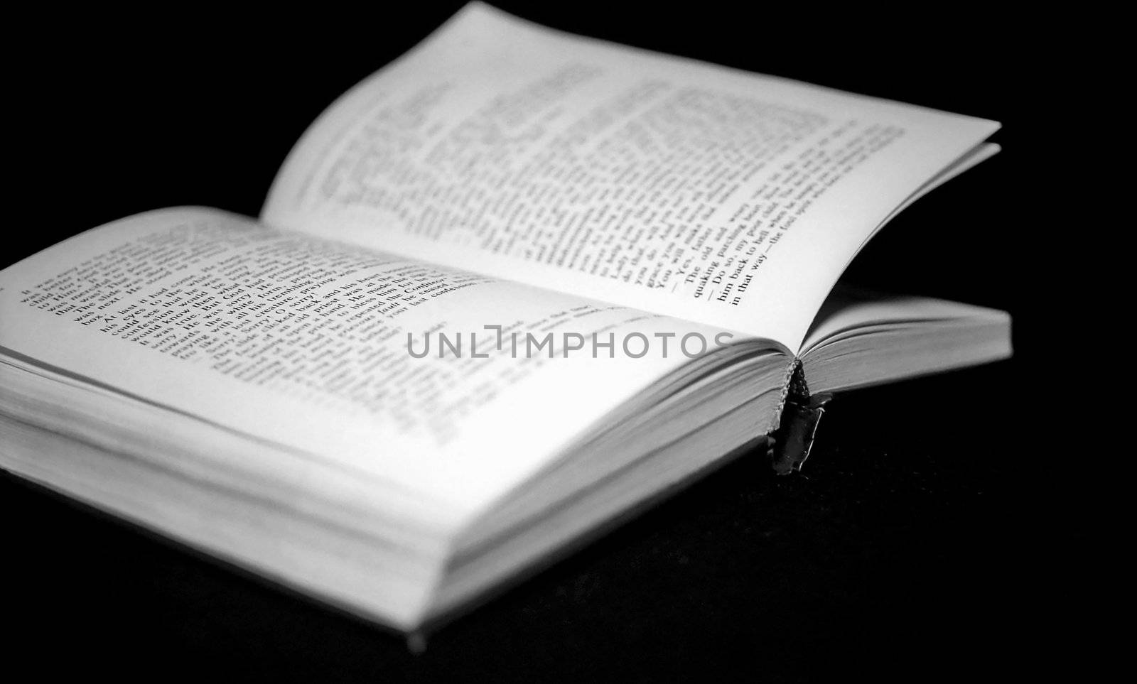 Pages of open book on bkack background monochrome