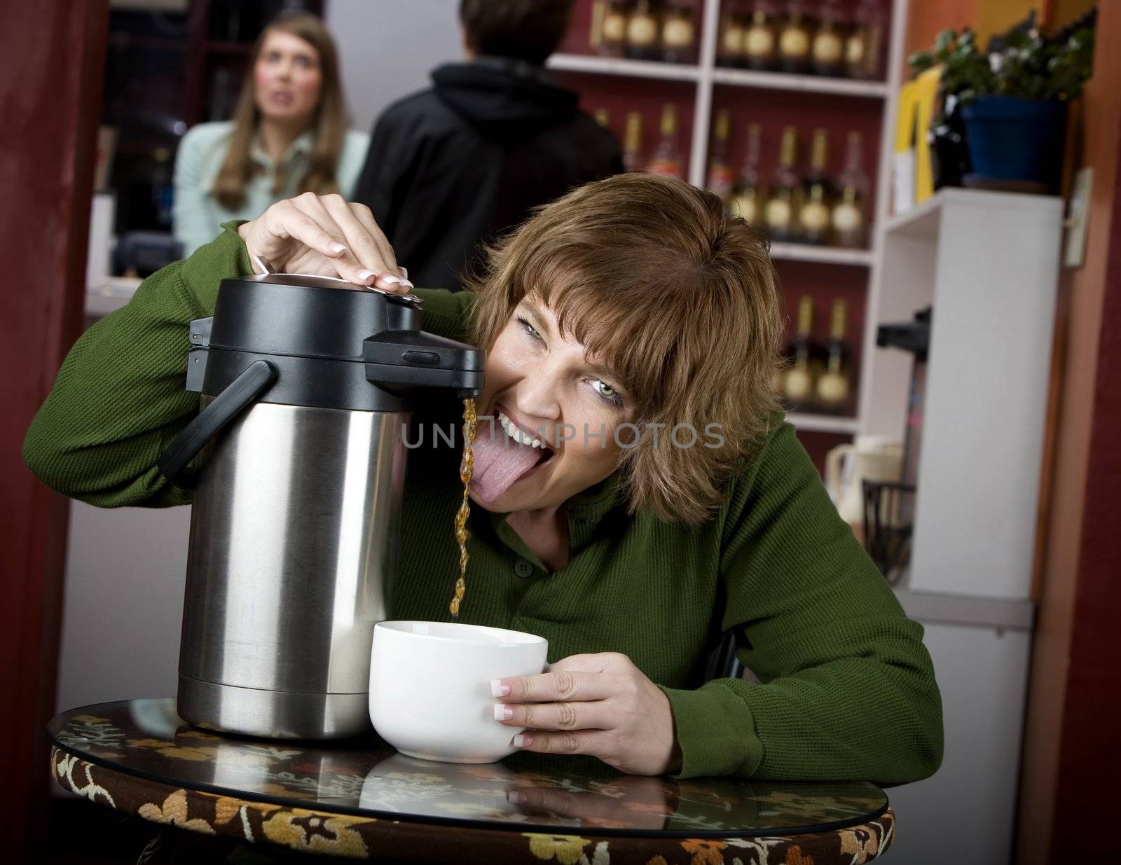 Woman drinking coffee directly from a beverage dispenser