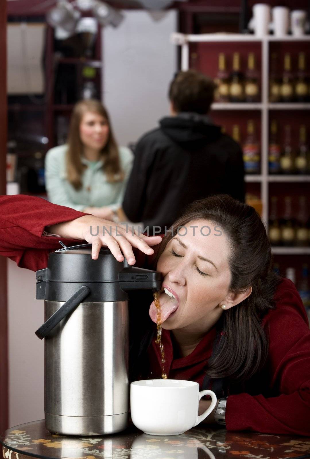 Woman drinking coffee directly from a beverage dispenser