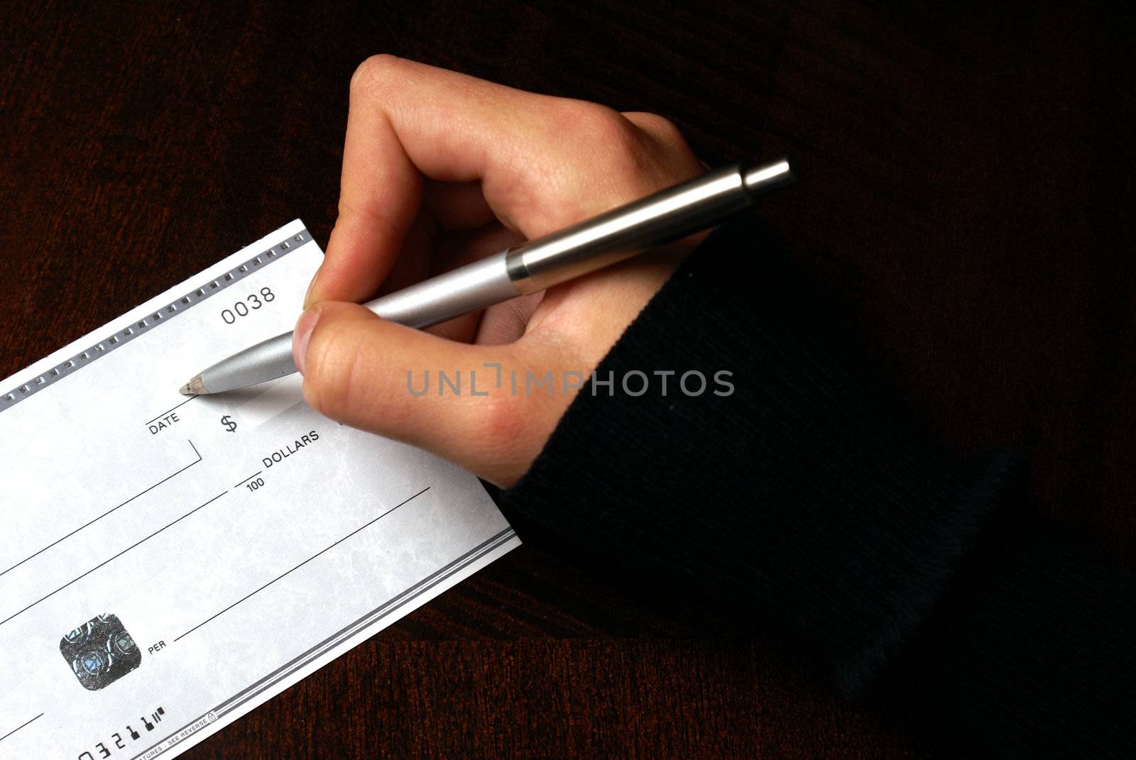 A macro of someone writing a cheque.