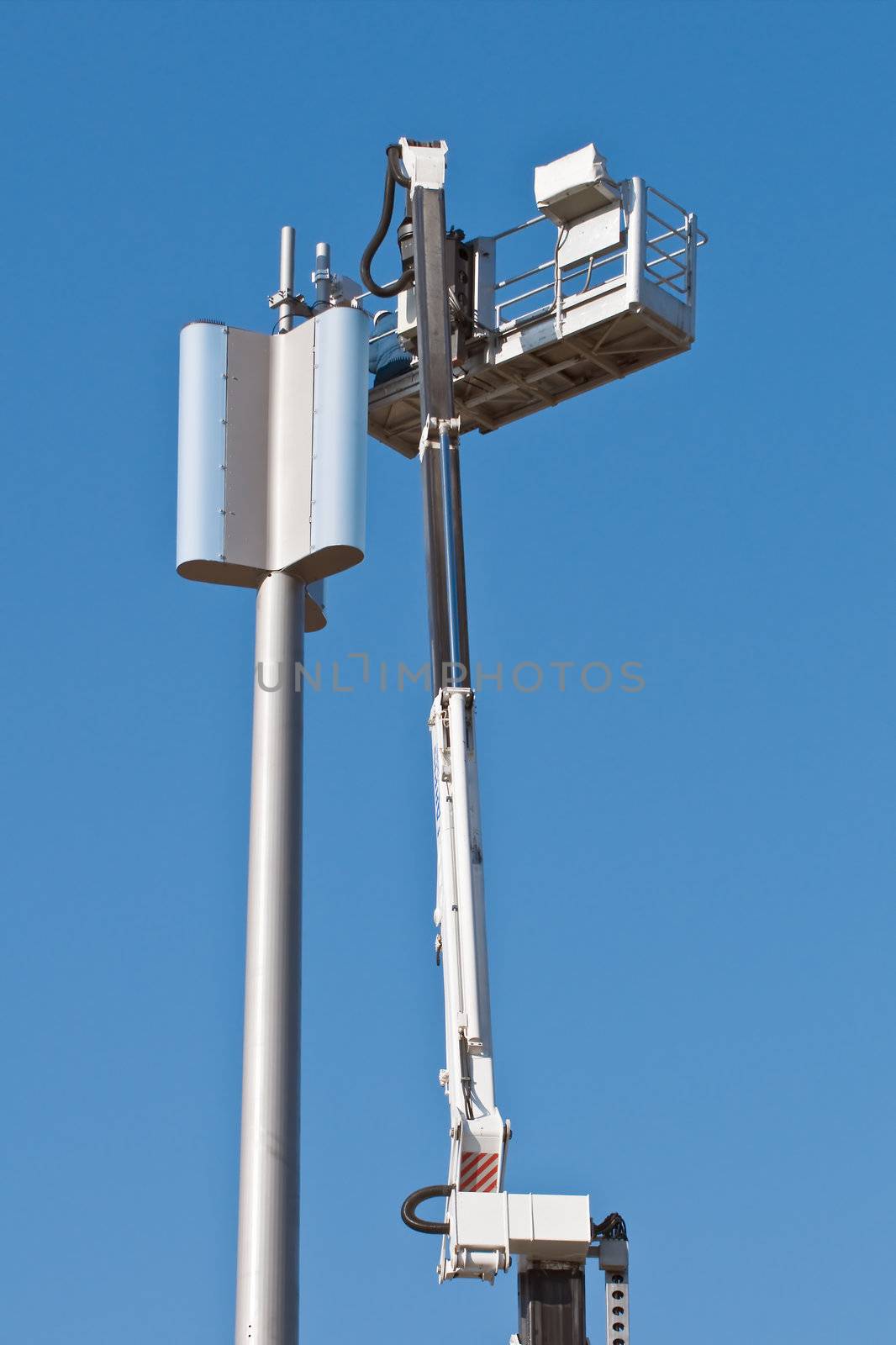 Installation of a GSM antenna with a worker on platform