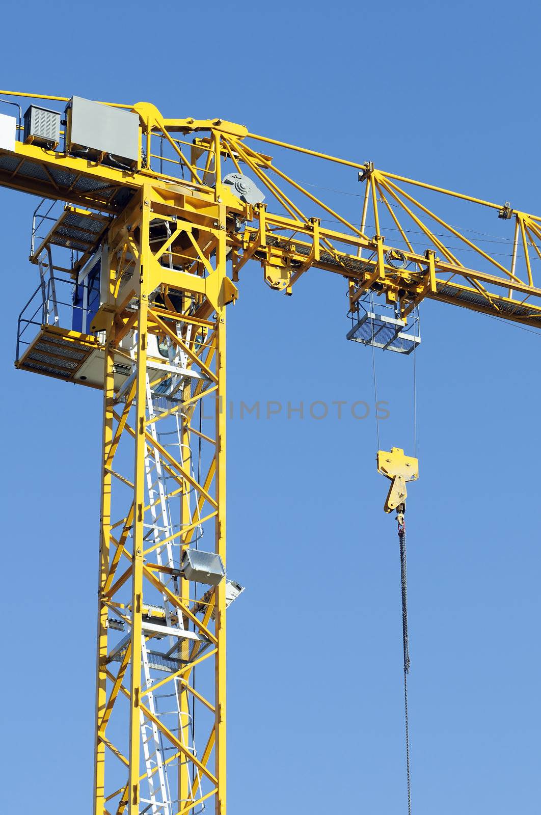Yellow crane against a blue sky