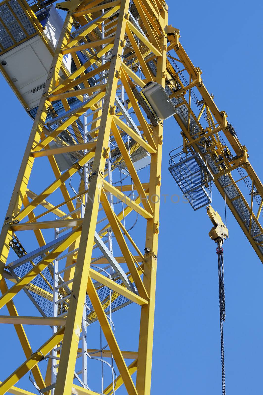 Detail of yellow crane in construction industry