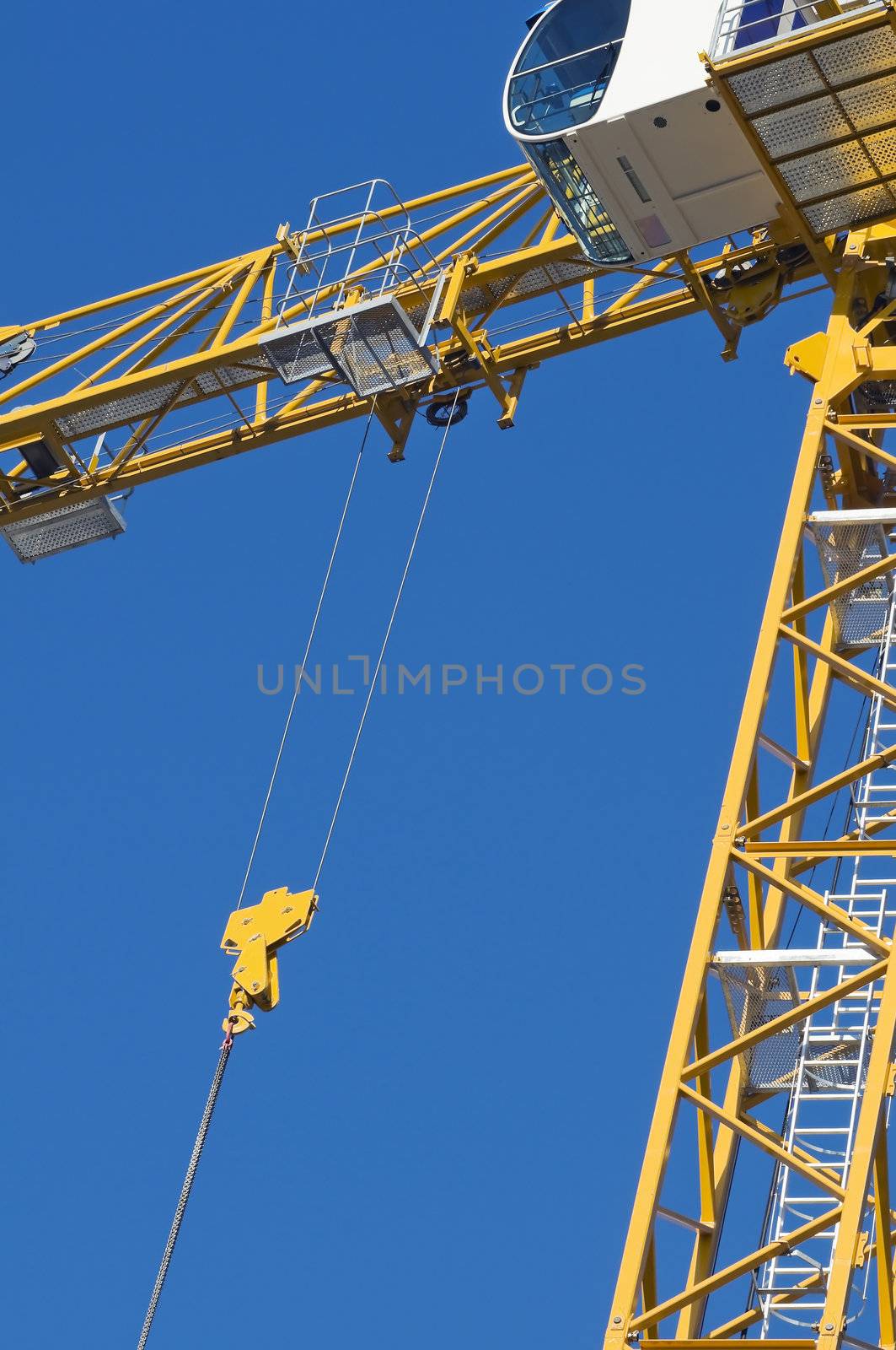 Yellow crane against a blue the sky