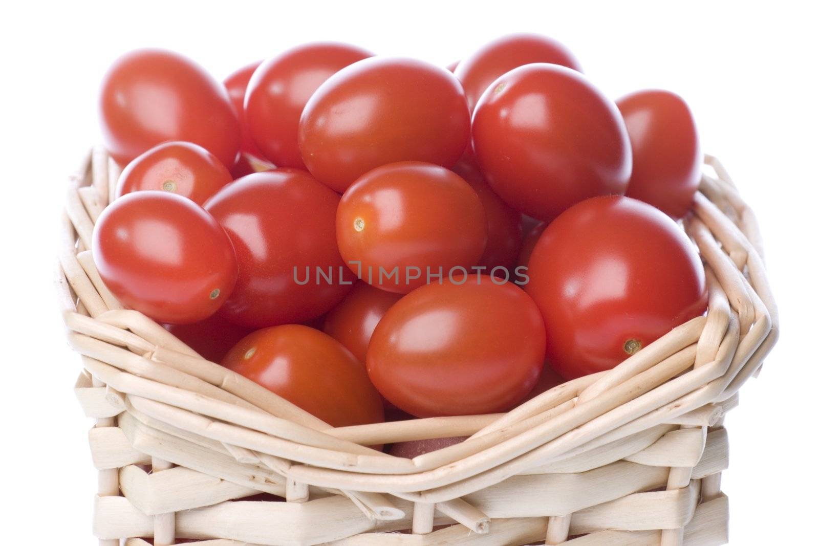 Isolated image of cherry tomatoes in a basket.