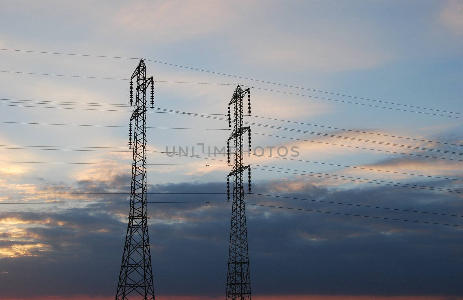 Electrical towers and wires on sky background