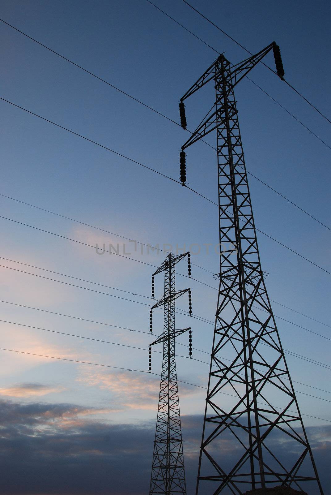 Electrical towers and wires on sky background