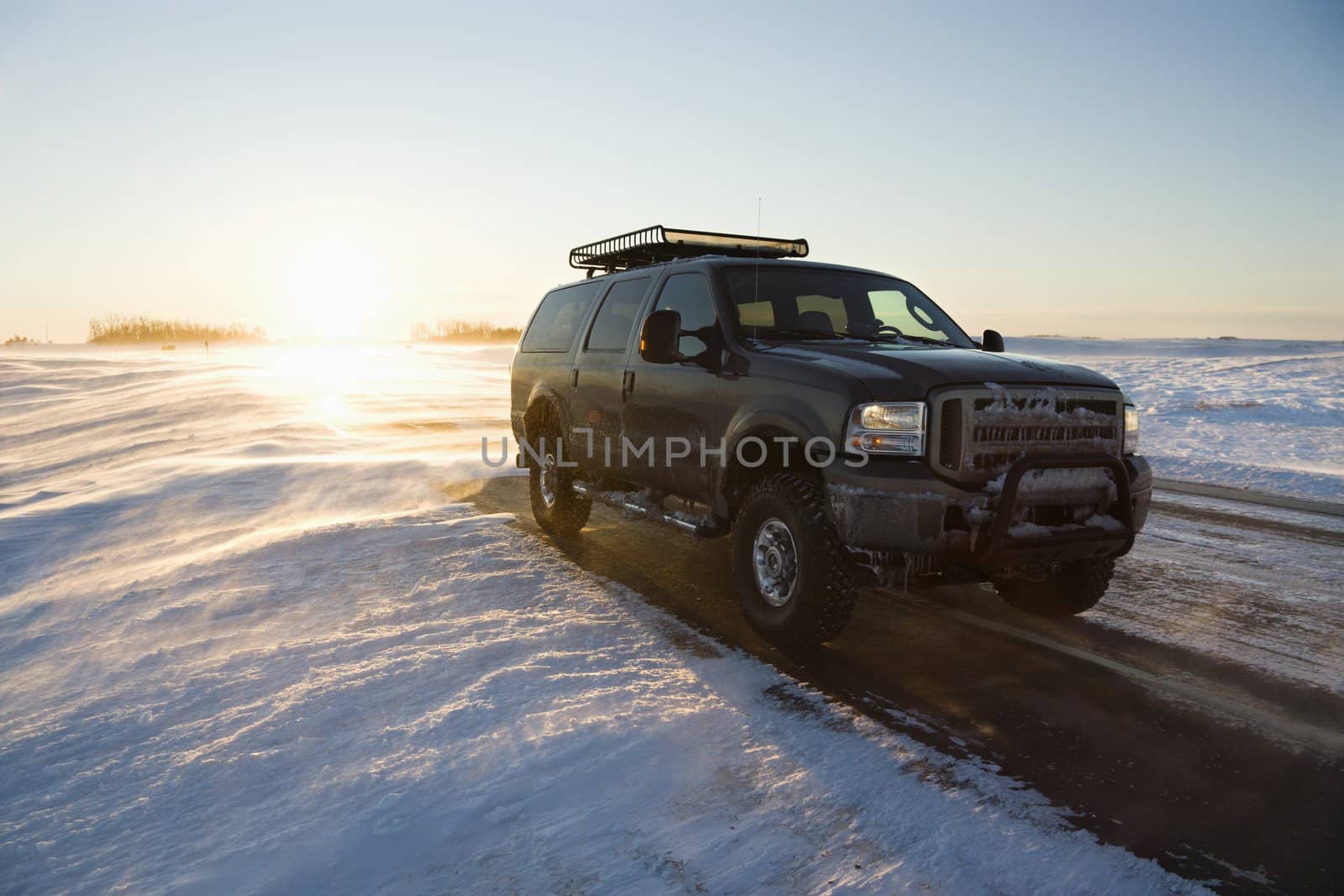 Truck on icy road. by iofoto