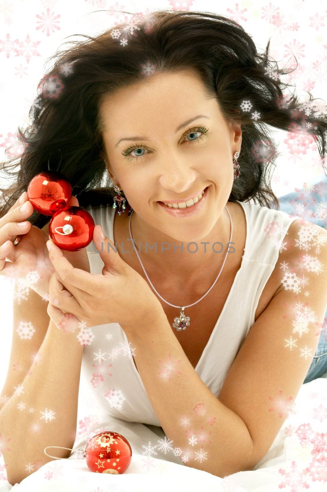 happy girl with christmas tree balls surrounded by rendered snowflakes