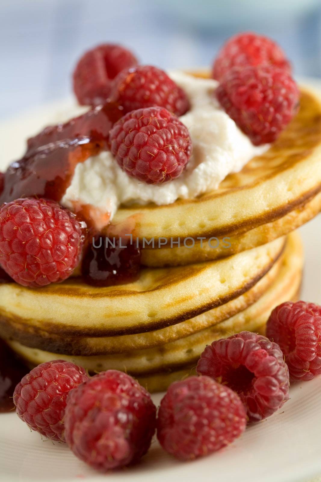 Delicious breakfast with pancakes and raspberries