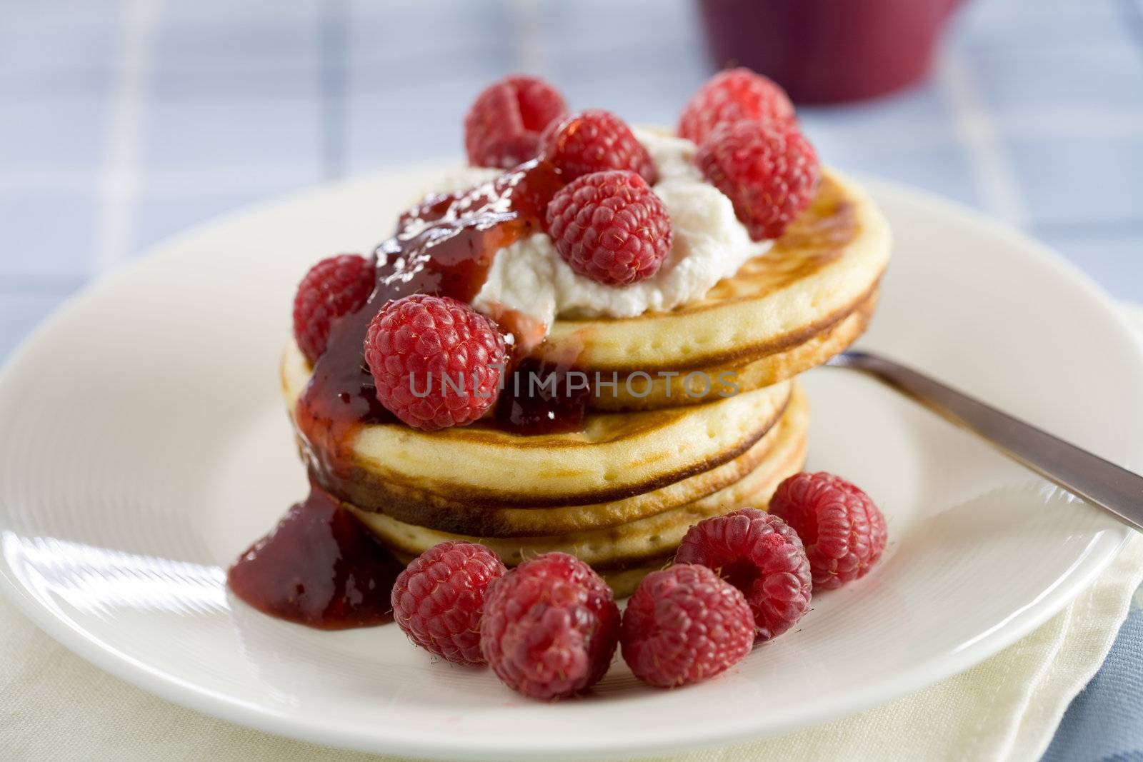 Delicious pancakes with ricotta cream and raspberries