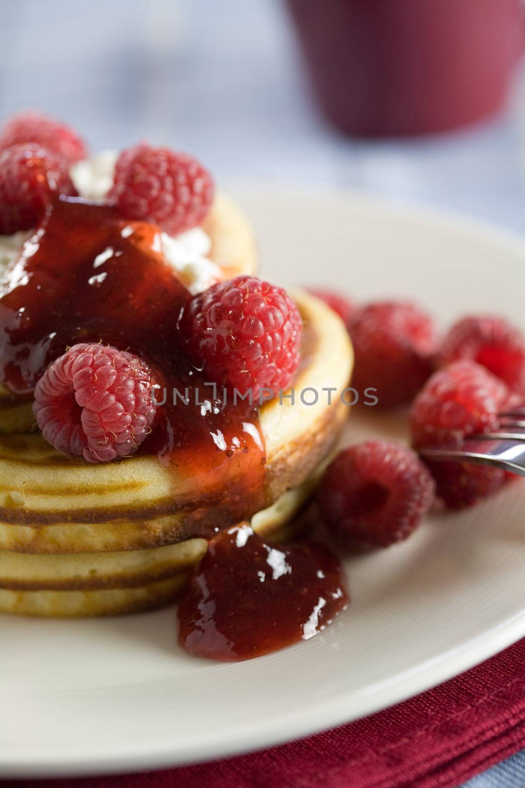 Delicious stack of pancakes served with raspberries