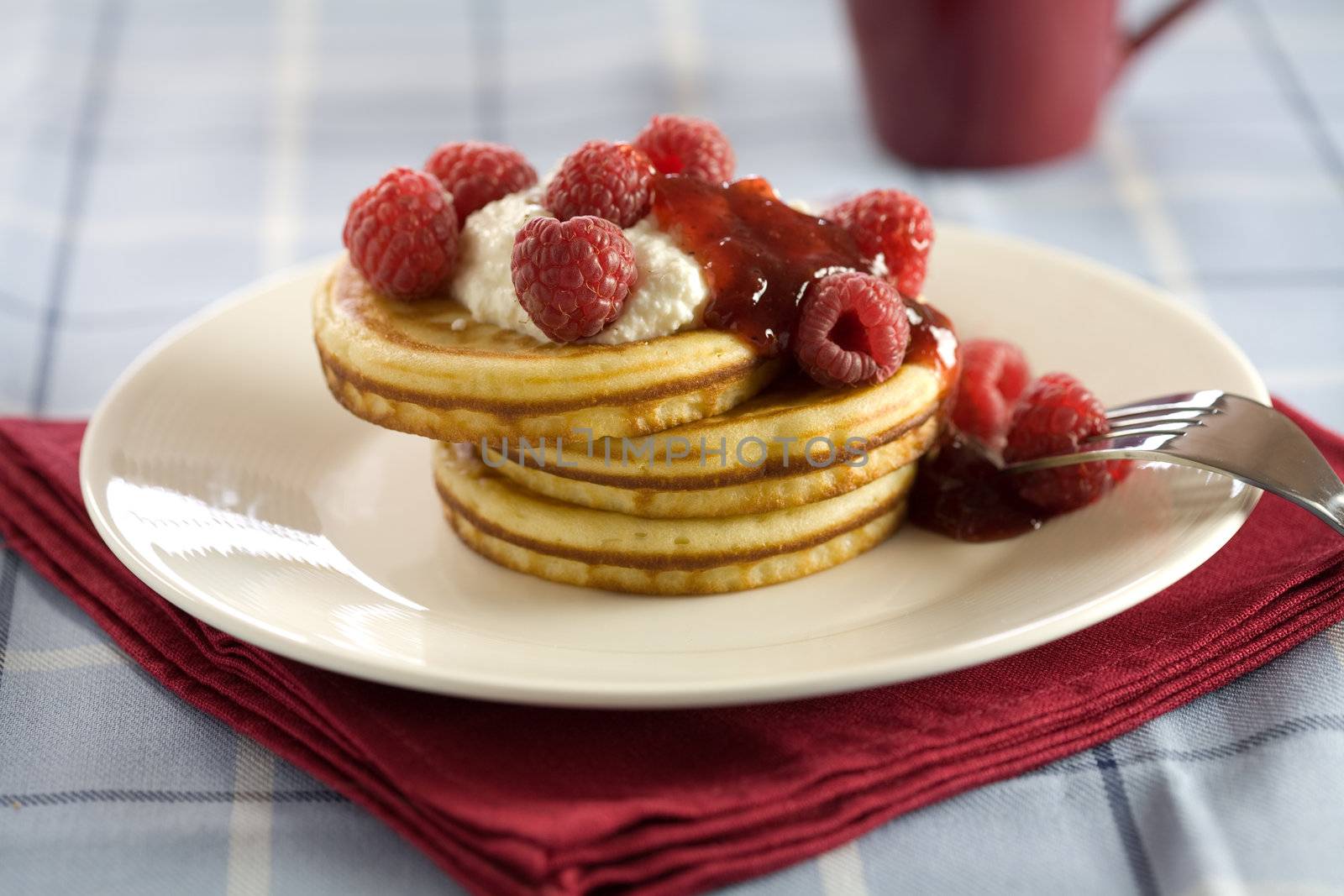 Delicious pancakes with ricotaa and raspberries