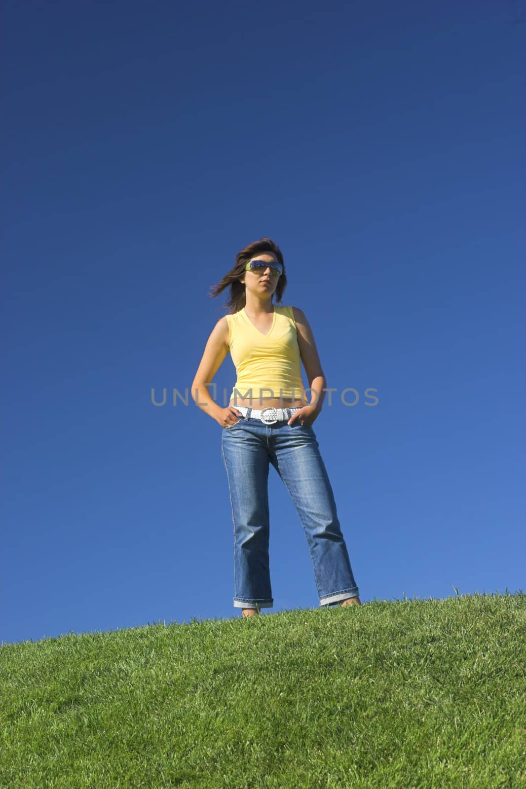 Beautiful woman posing on a green field