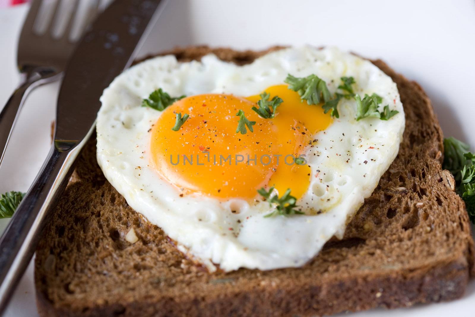 Heart shaped fried egg on a sandwich