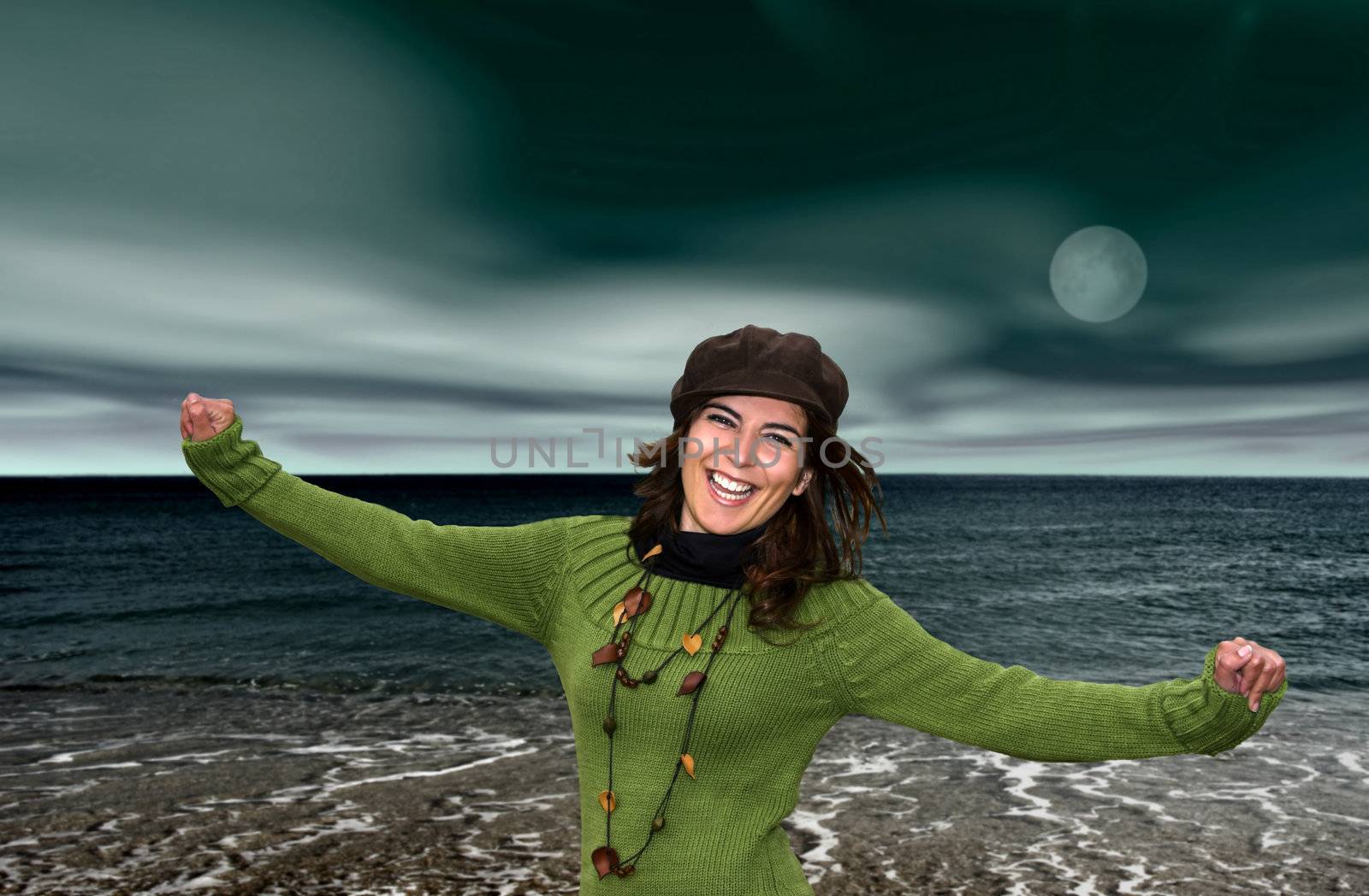 Young happy woman in beach at night