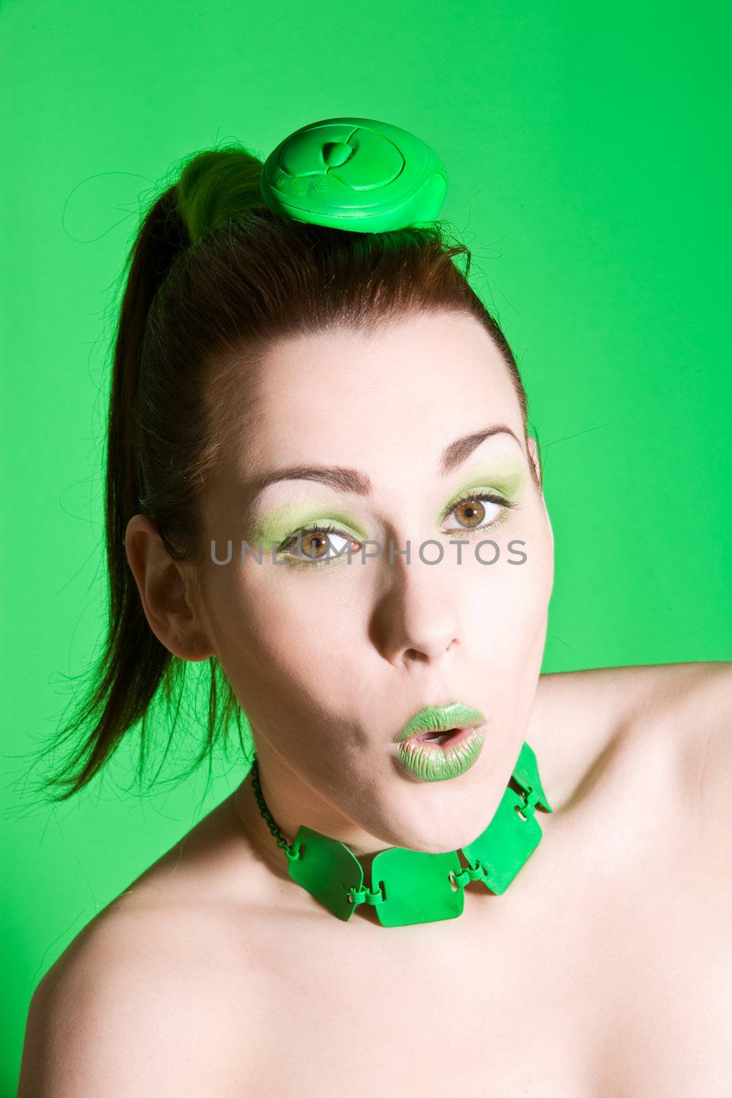 Funny girl with a green computer mouse on her head