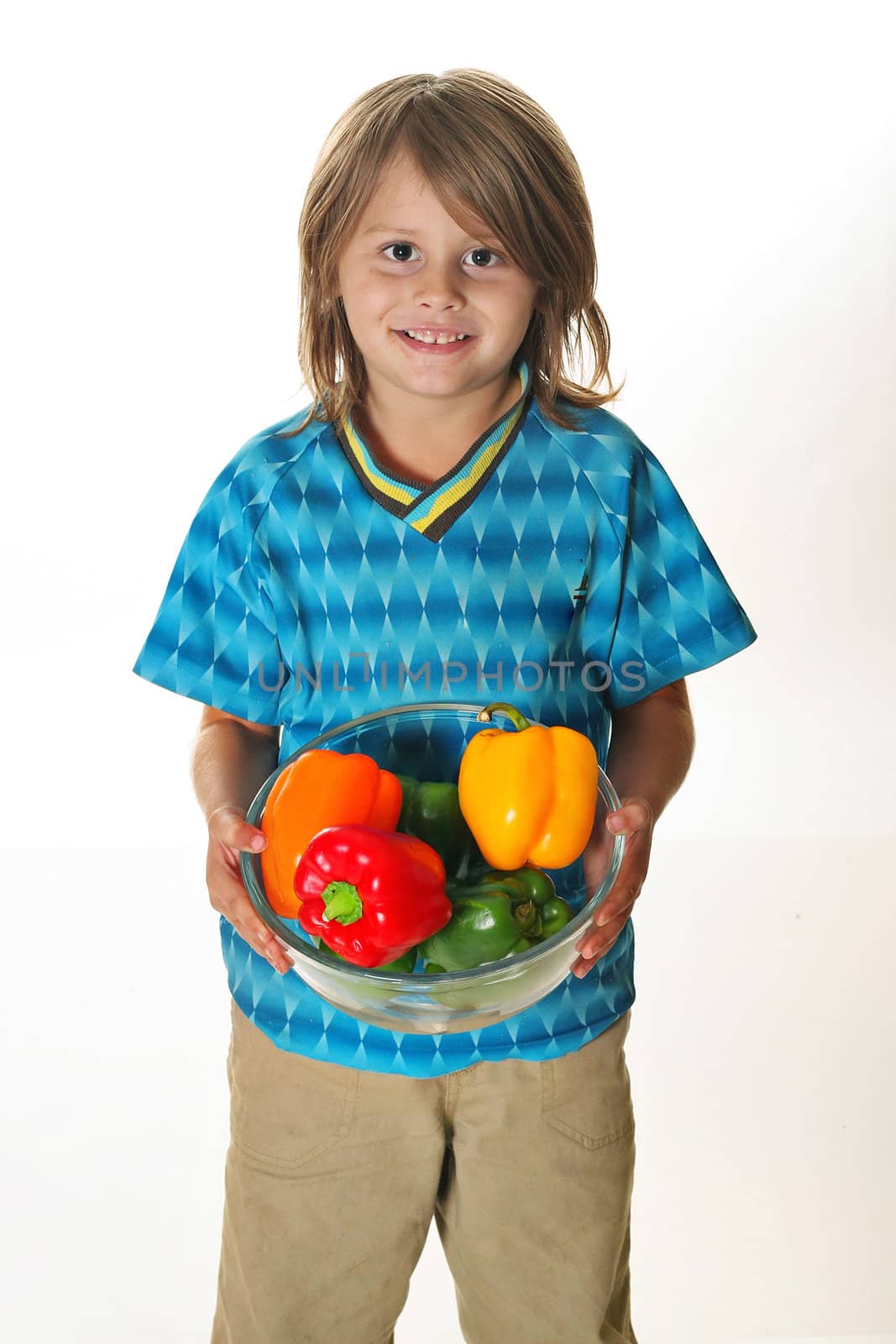 little boy holding colorful peppers