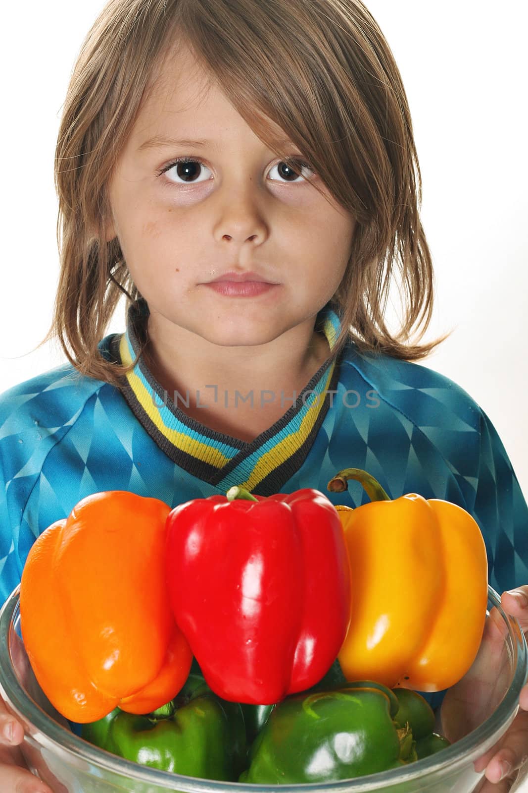 shot of little boy with colorful peppers by creativestock