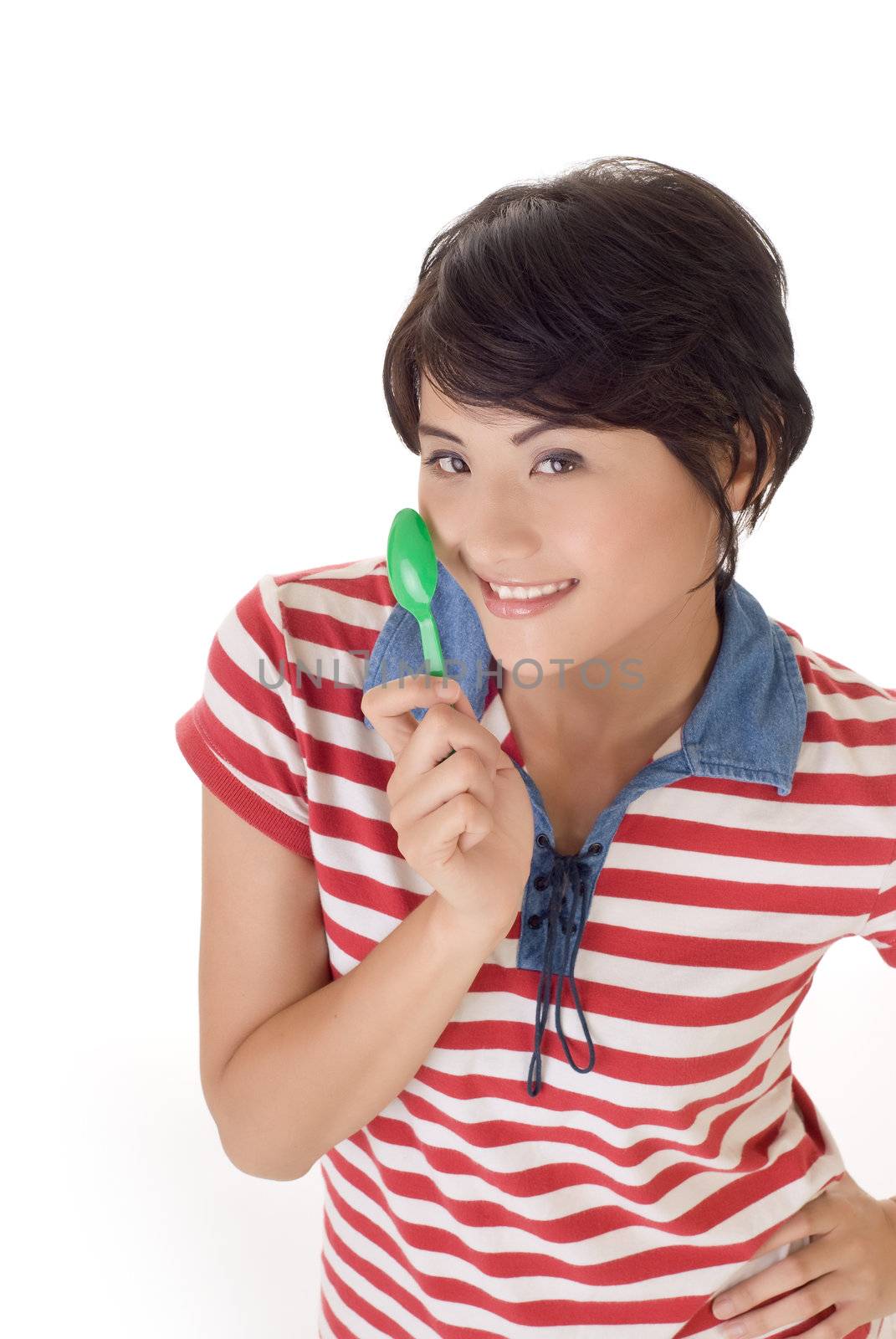 Happy eating time, closeup portrait of girl holding tablespoon and smiling on white background.