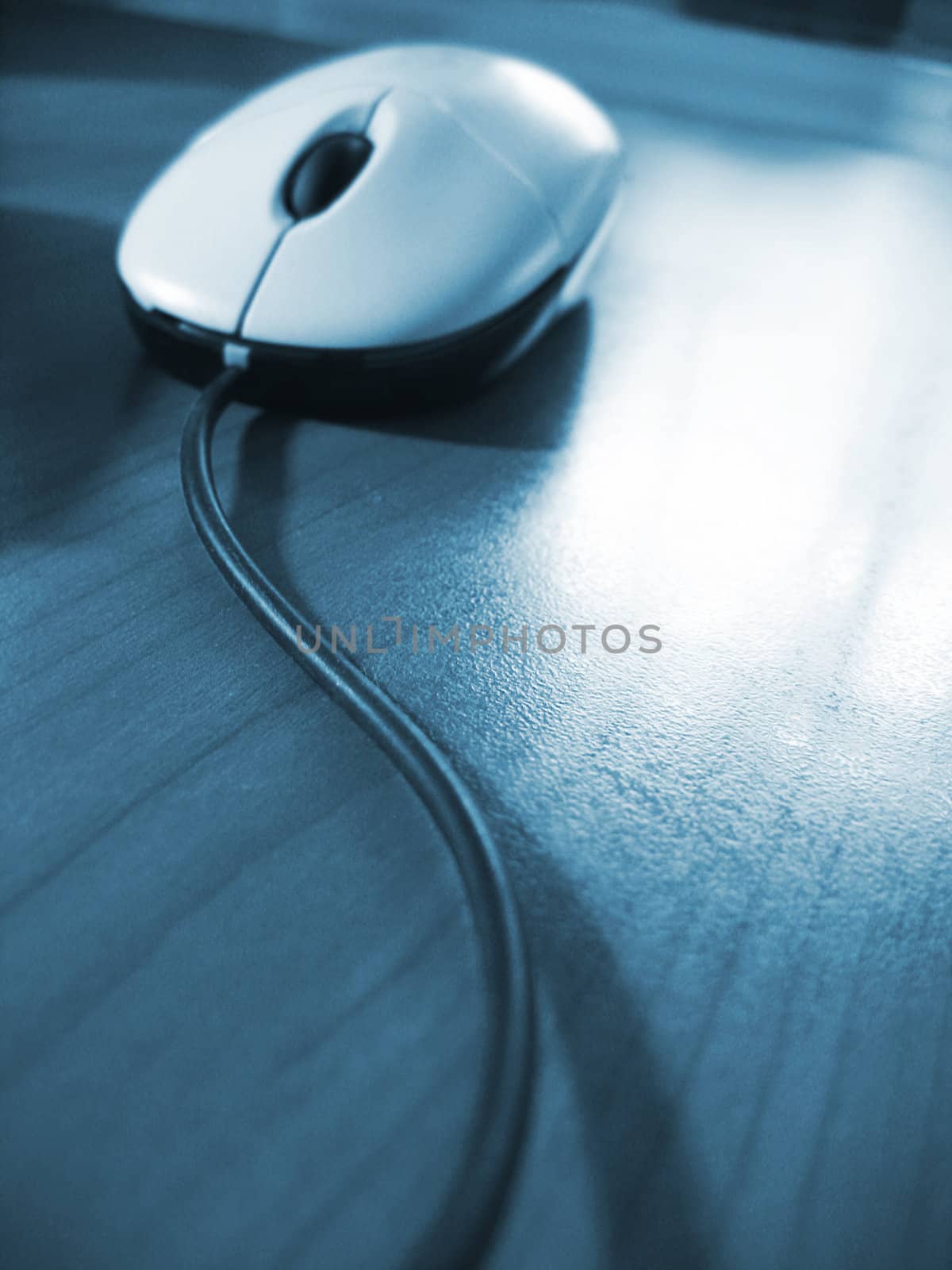 mouse on desk, blue toned image