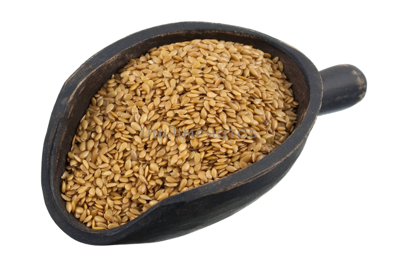 golden flax seeds on a rustic, wooden, dark painted scoop, isolated on white