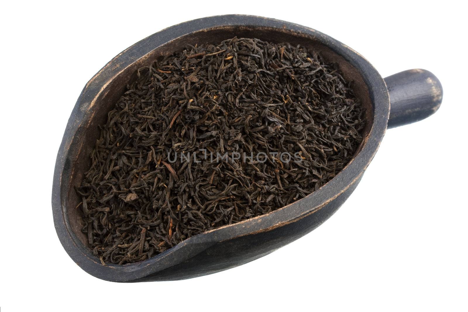full leaf loose breakfast keemun oolong tea on a rustic, wooden scoop, isolated on white