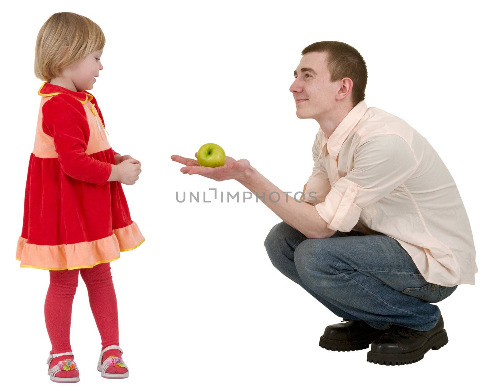 Young man give green apple to little girl