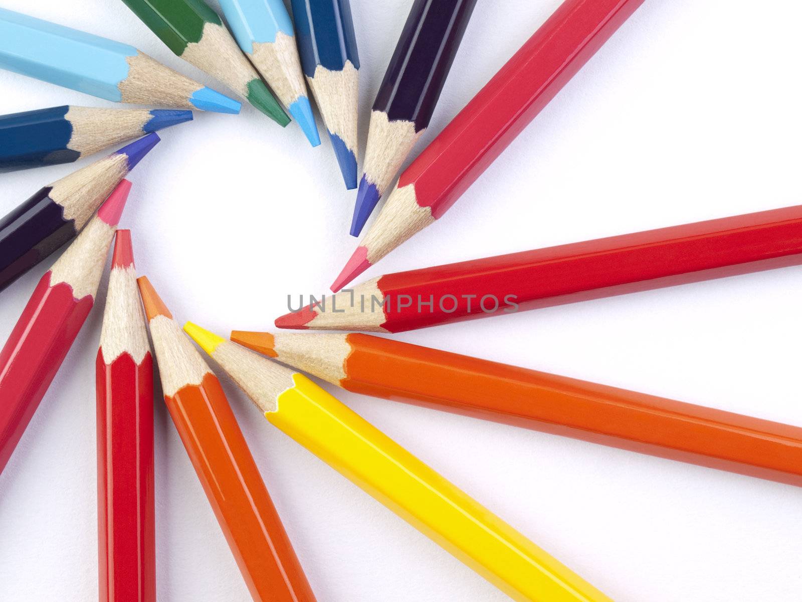 A circle formed by the points of several colored pencils.