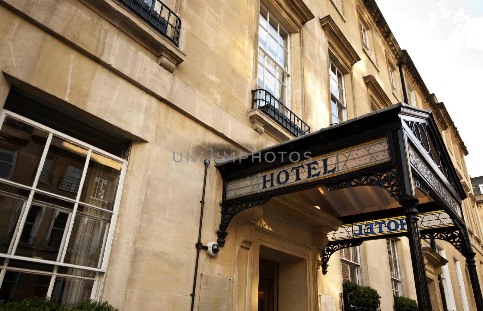 Hotel sign over the entrance to an old stone building