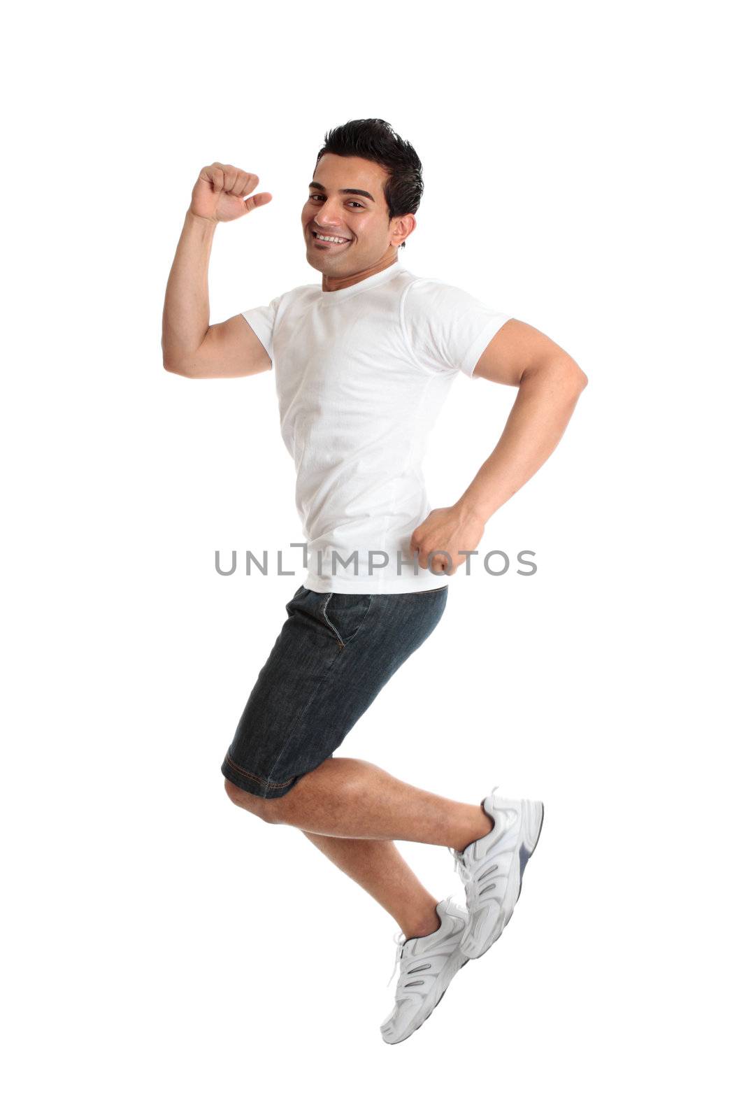 An excited jumping leaping man wearing casual clothes - success victory triumph.  Joyful young person smiling as he celebrates something.