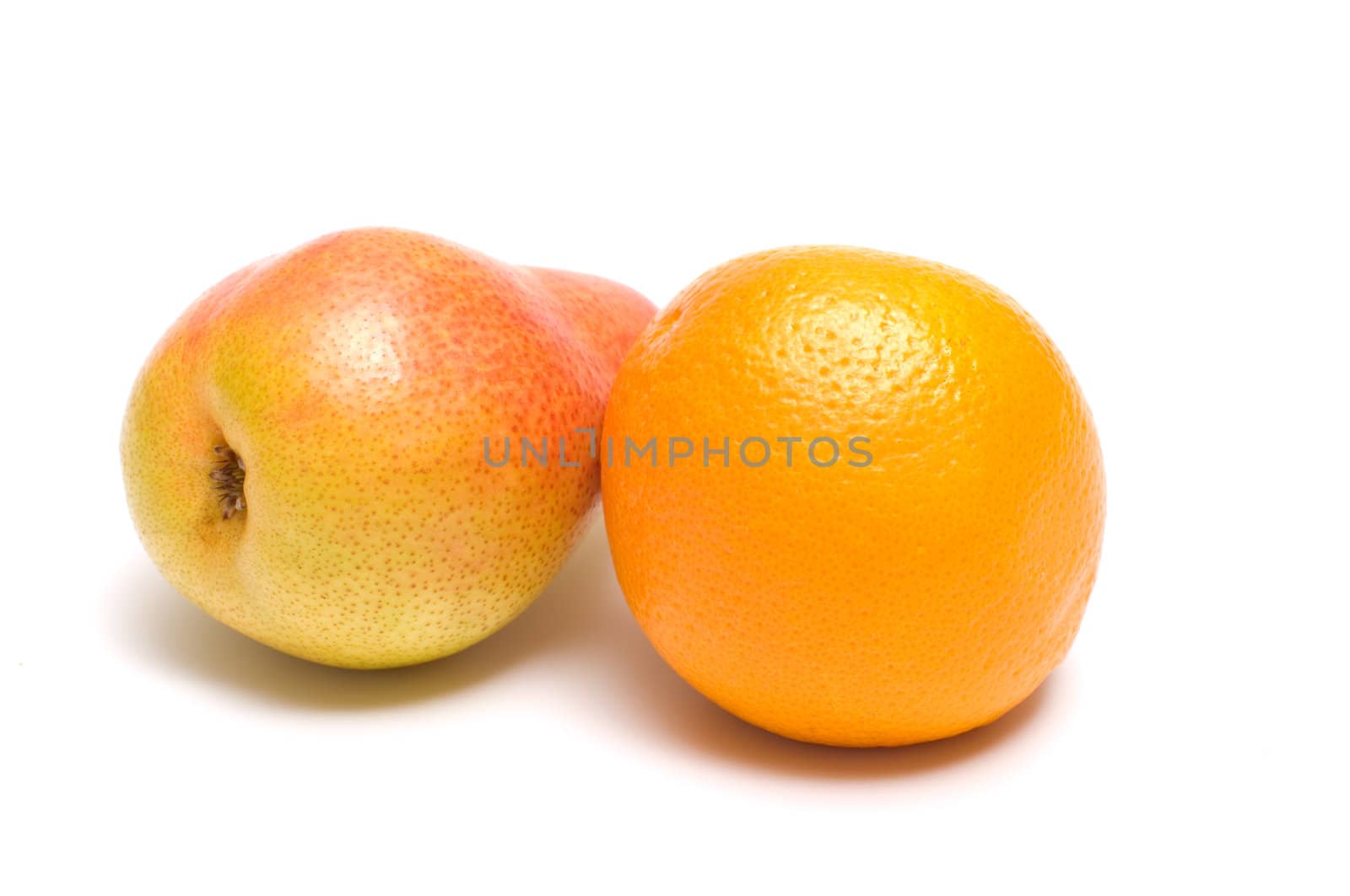 Pear and orange close up it is isolated on a white background.