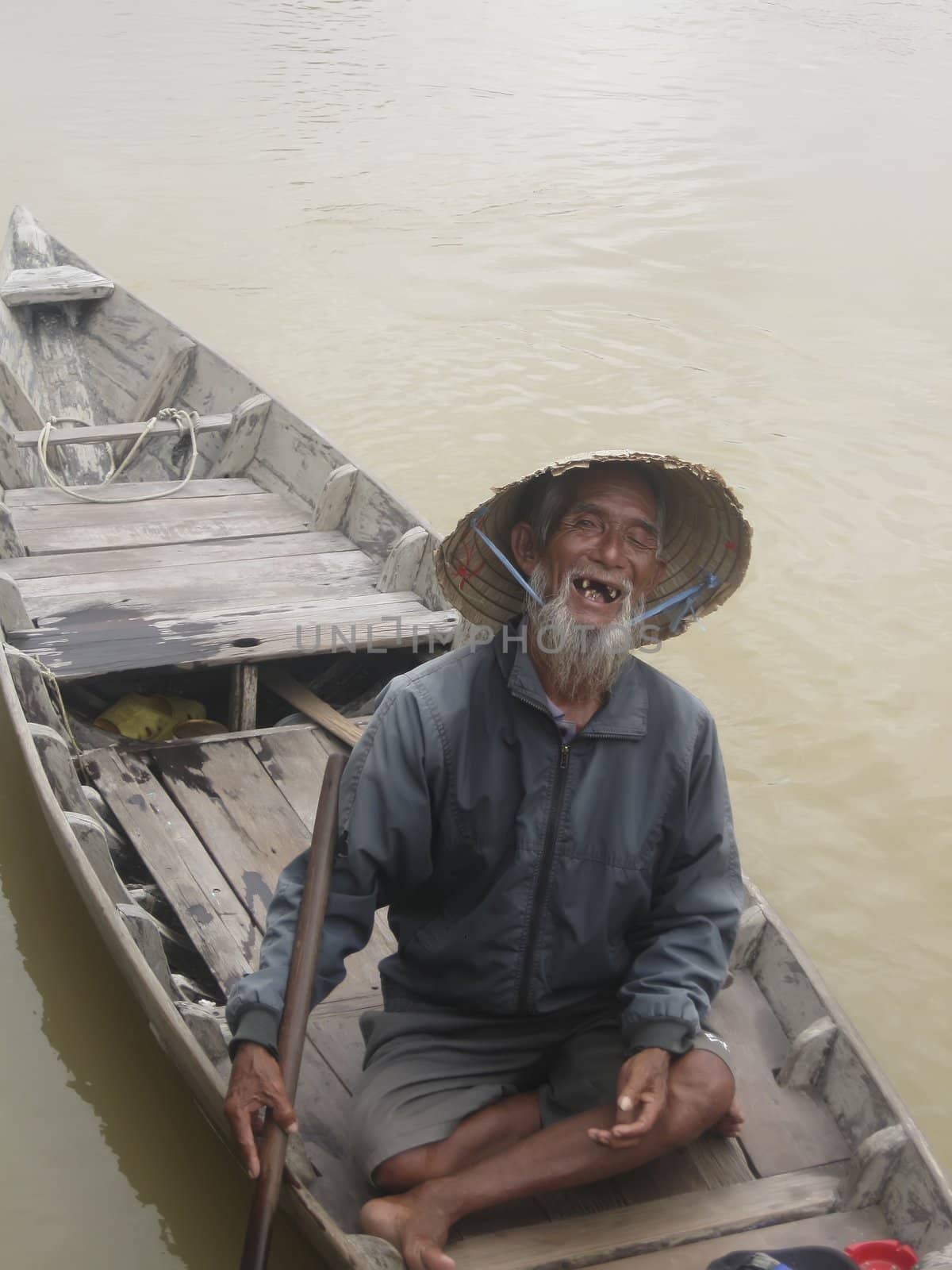 Old Fisherman In A Boat On The Thu Bon River by ppart