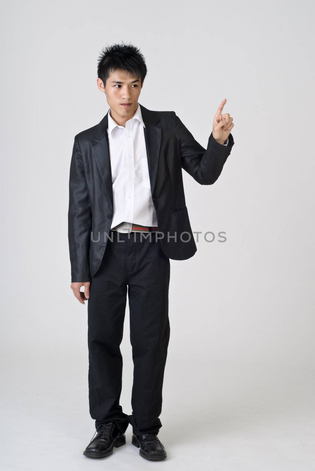 Young business man point, full length portrait of Asian.
